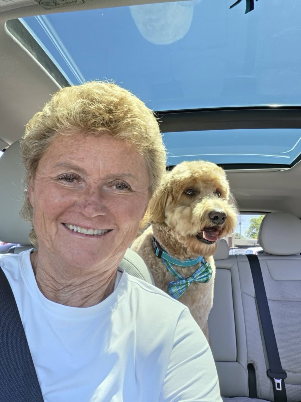 A happy client and her doodle in matching teal